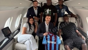 奥纳纳与家人、经纪人在飞机上合影，展示特拉布宗体育球衣